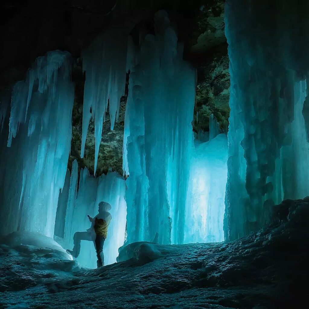 woman standing in the eben ice caves in munising