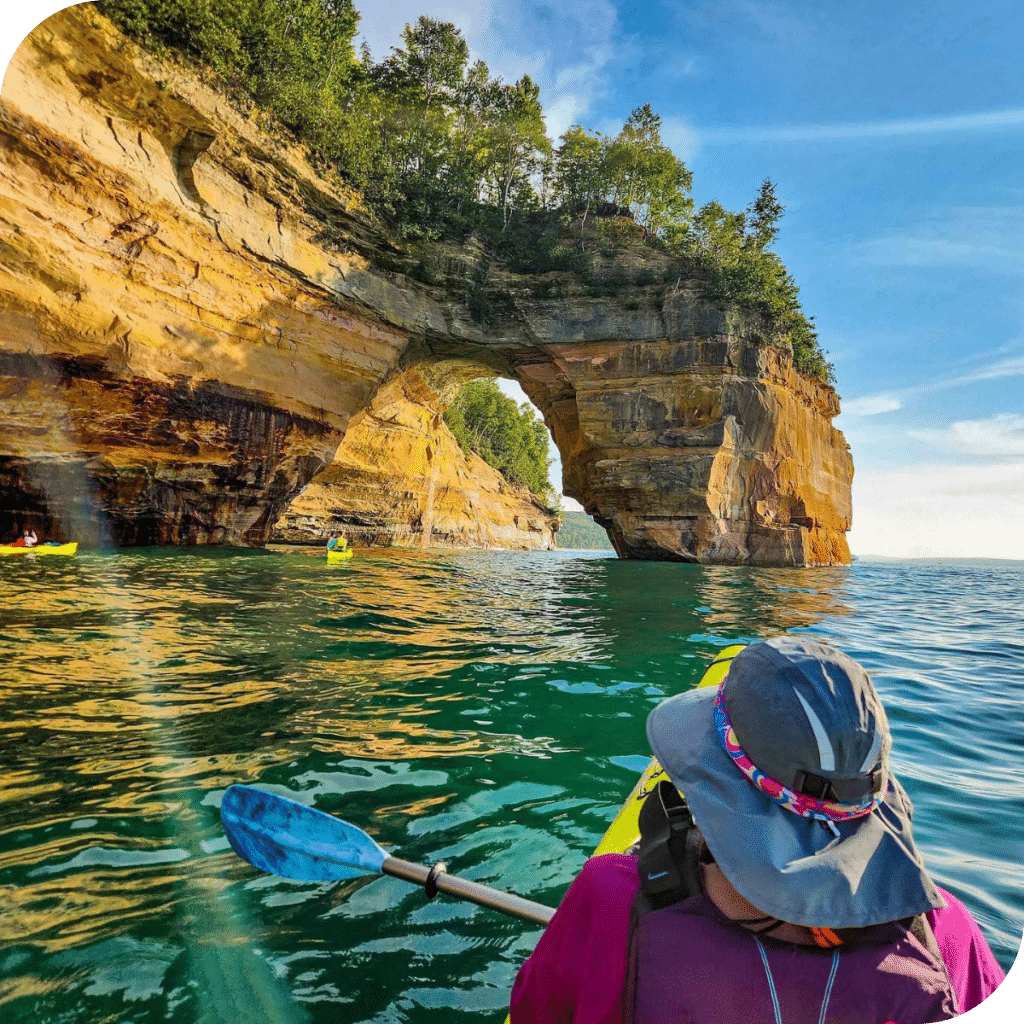 Person kayaking looking at Lovers Leap in Pictured Rocks
