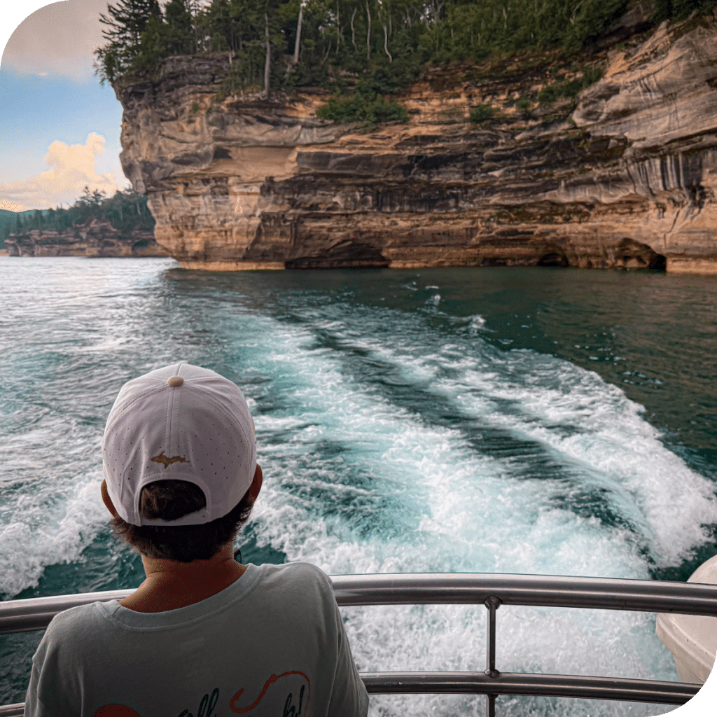 Child on a boat looking at the Pictured Rocks National Lakeshore