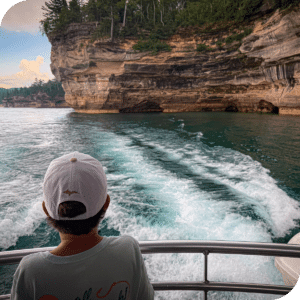 Child on a boat looking at the Pictured Rocks National Lakeshore